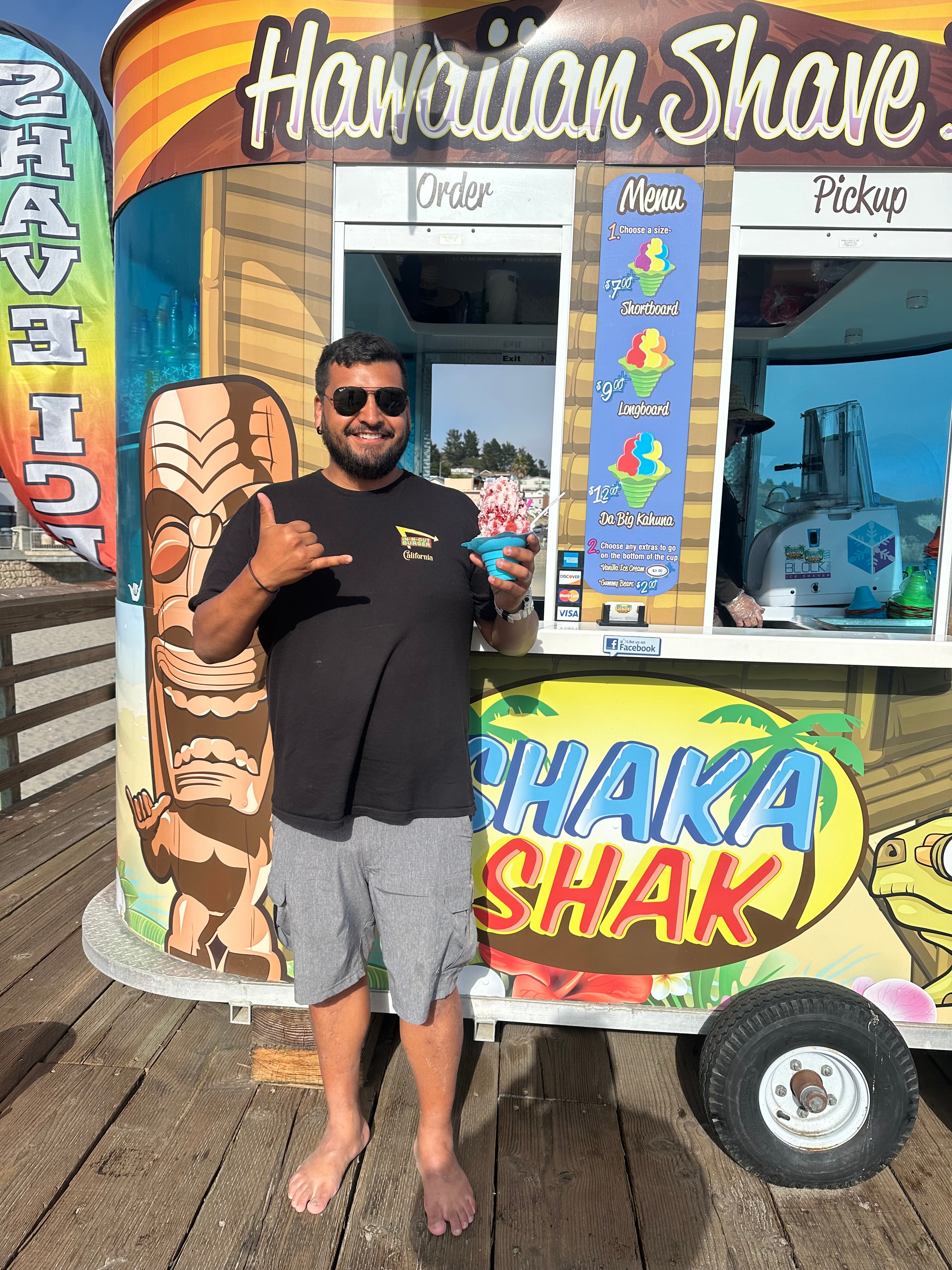 Owner posing in front of the Shaka Shak truck
