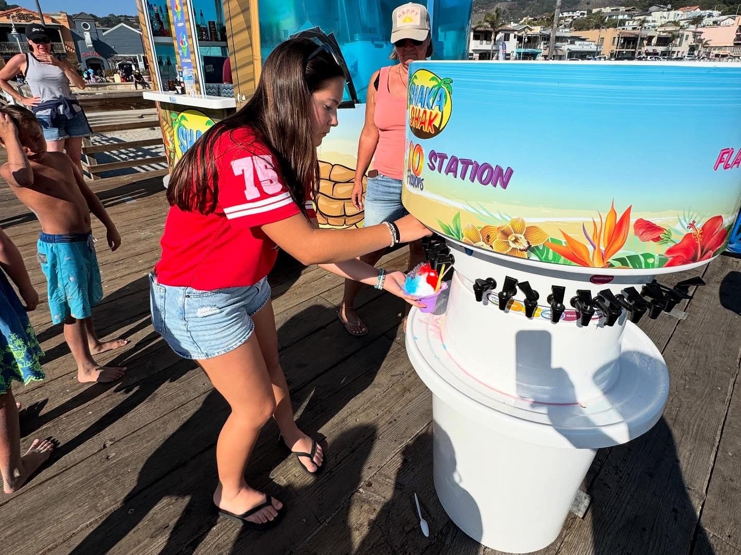 Customer adding flavors at the Shaka Shak flavor station on the pier