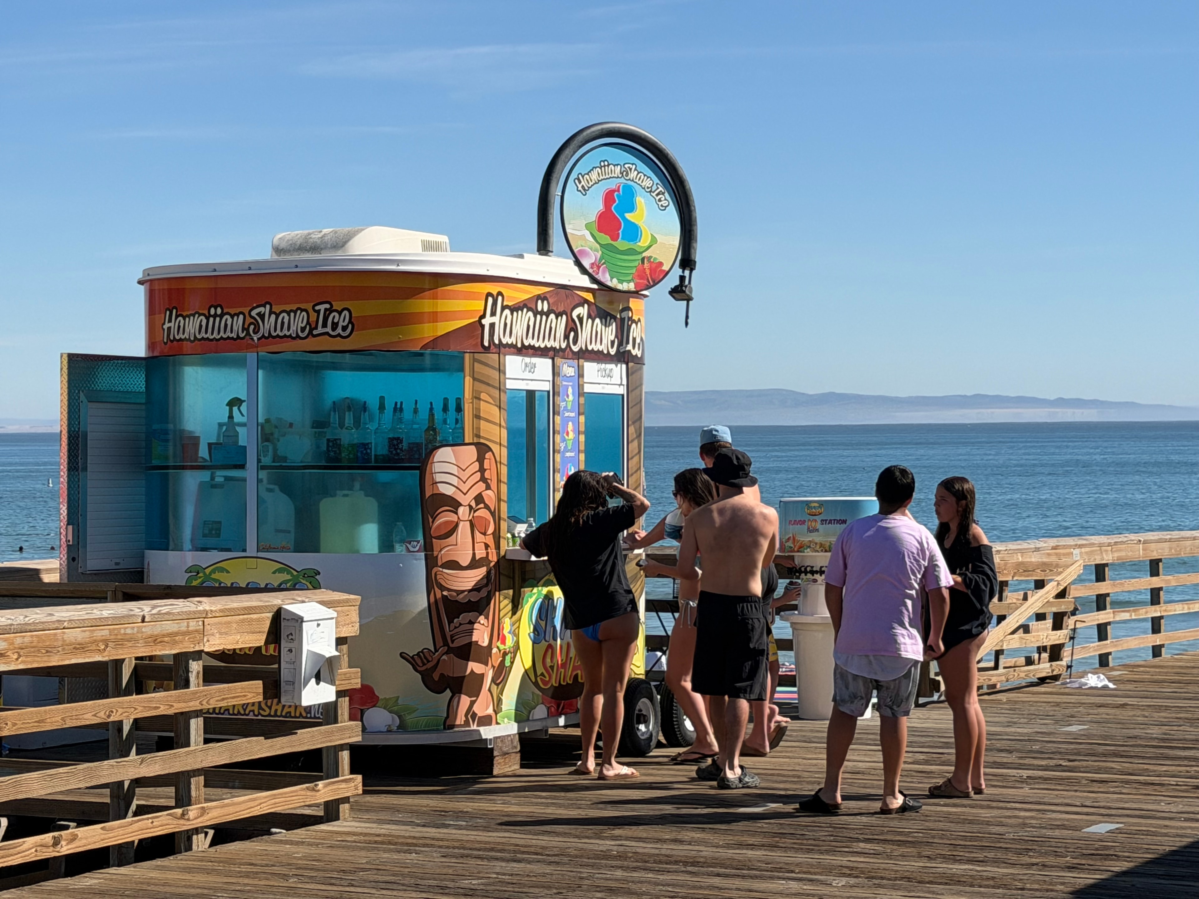 Customers ordering at the Shaka Shak kiosk on the Avila Beach pier