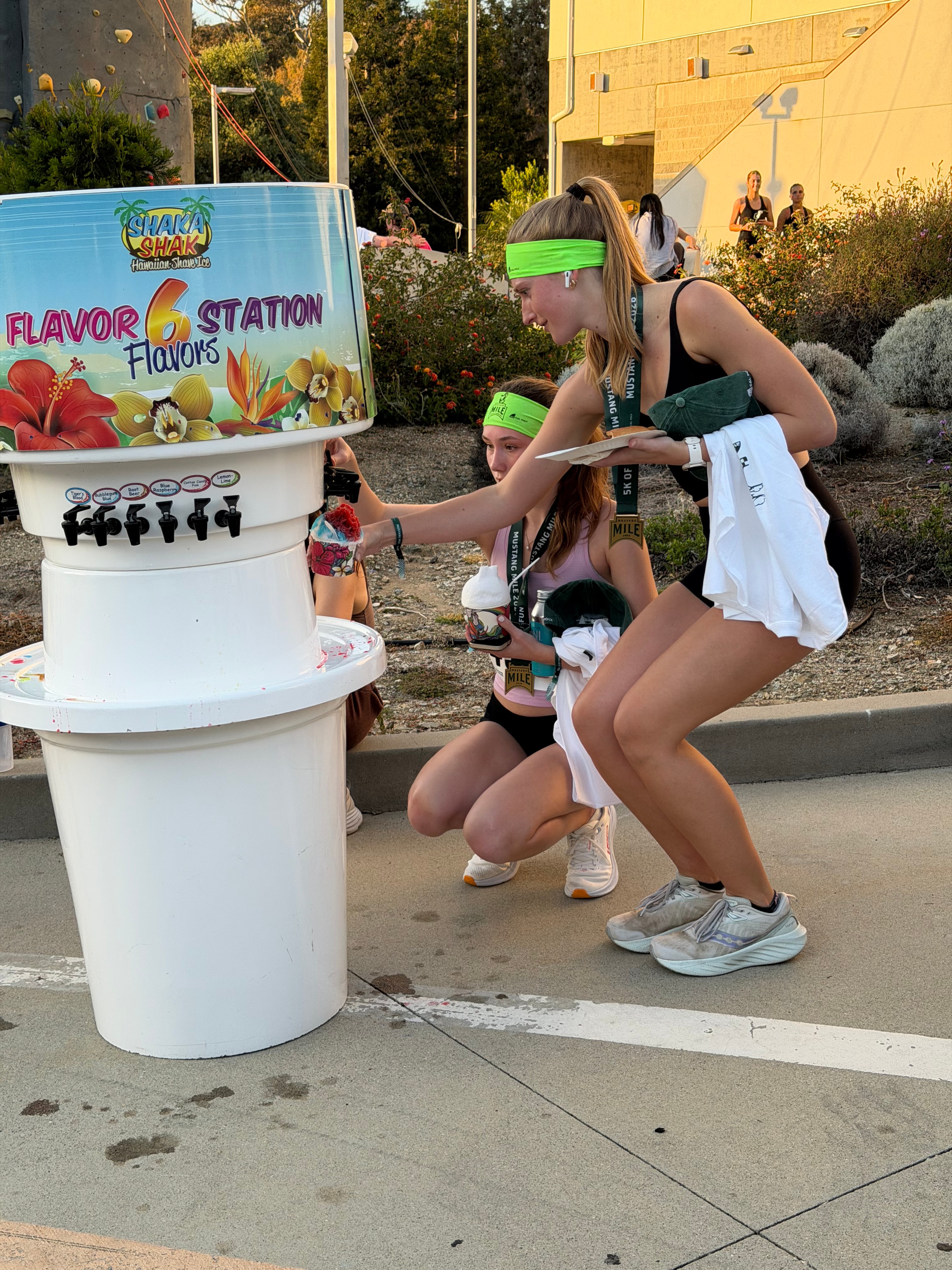 Mustang Mile runners using the Shaka Shak flavor station at the finish line