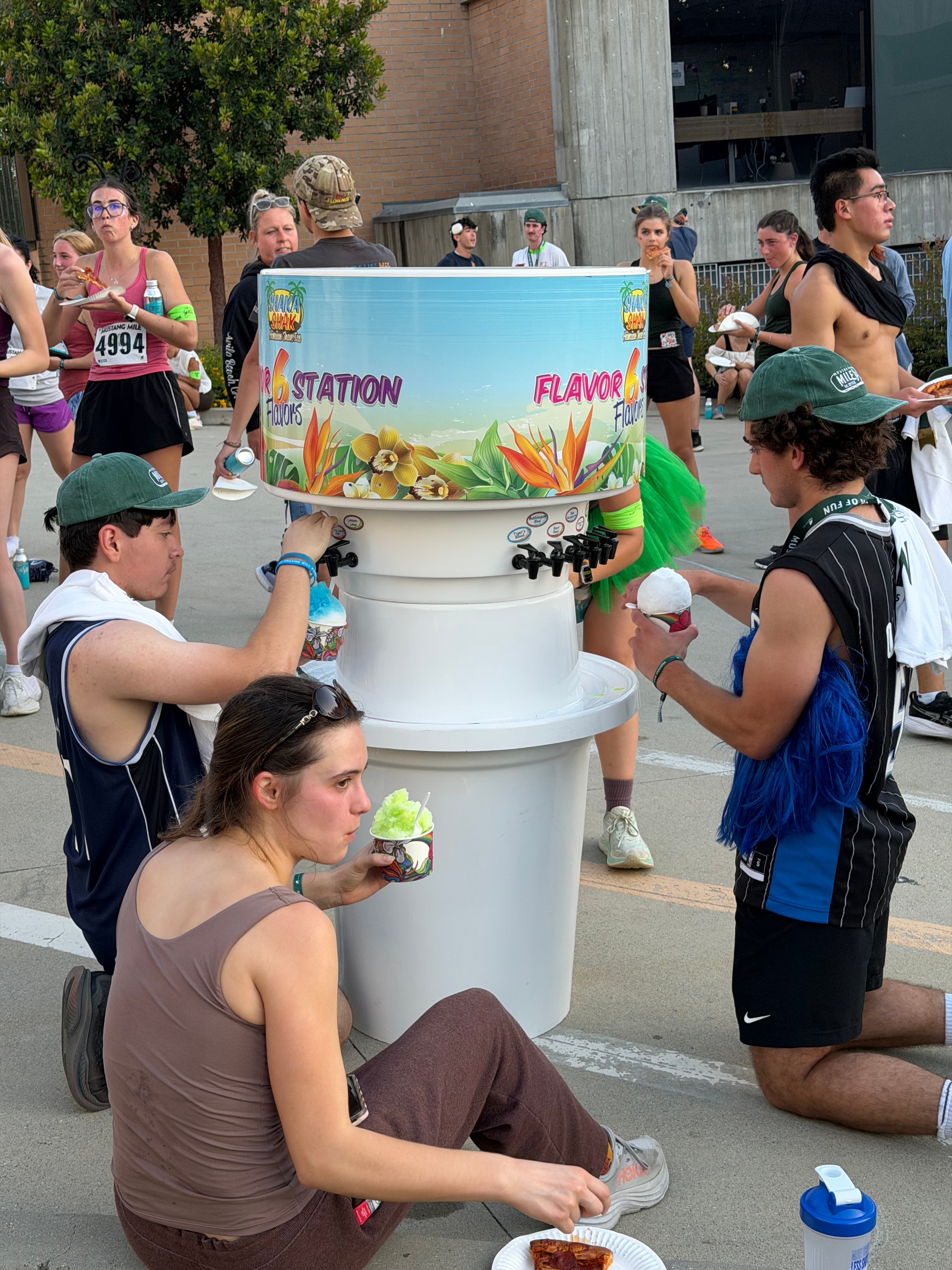 Crowd of Mustang Mile runners enjoying shave ice at the Shaka Shak flavor station