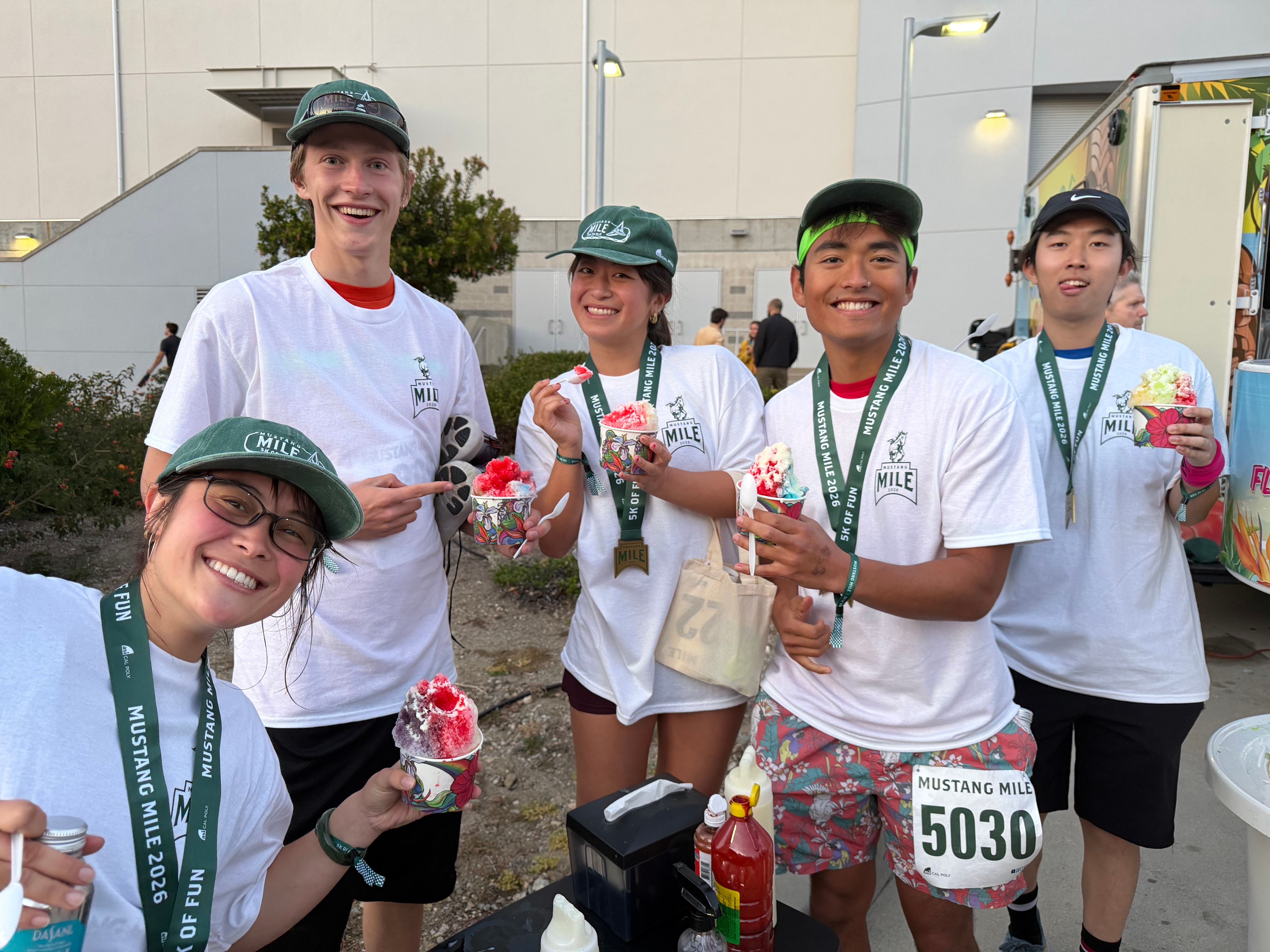 Group of five Mustang Mile finalists smiling with colorful shave ice cups