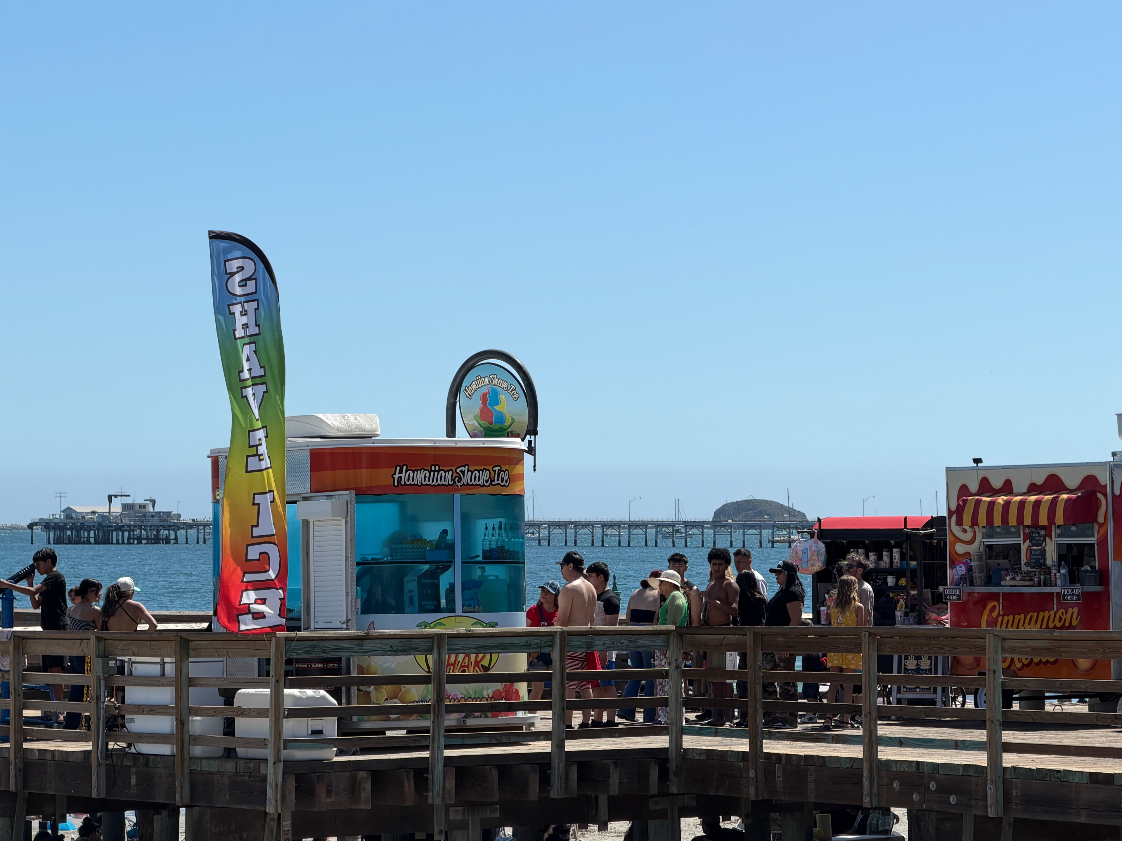 Long line of customers at the Shaka Shak Hawaiian Shave Ice kiosk on the pier