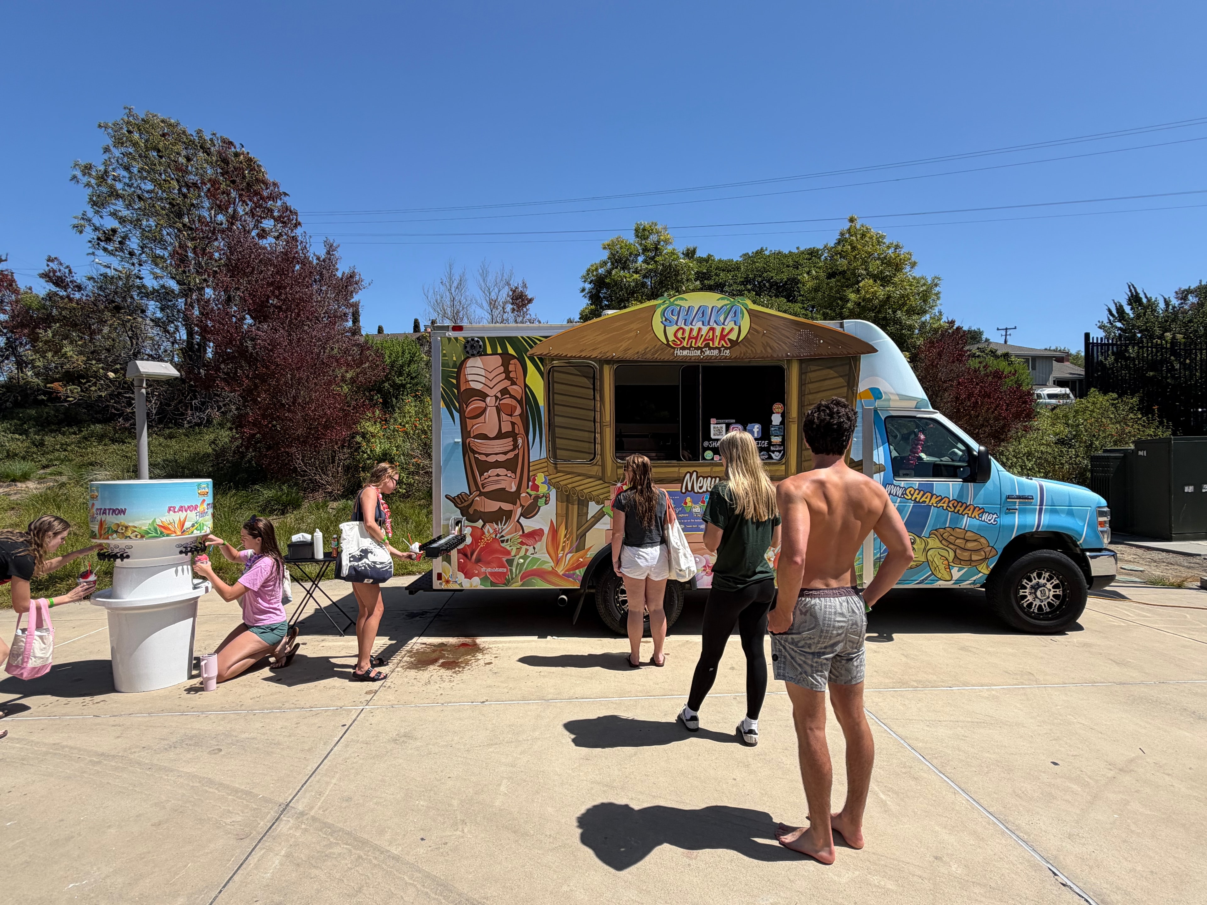 Shaka Shak truck with customers at the flavor station on a sunny day