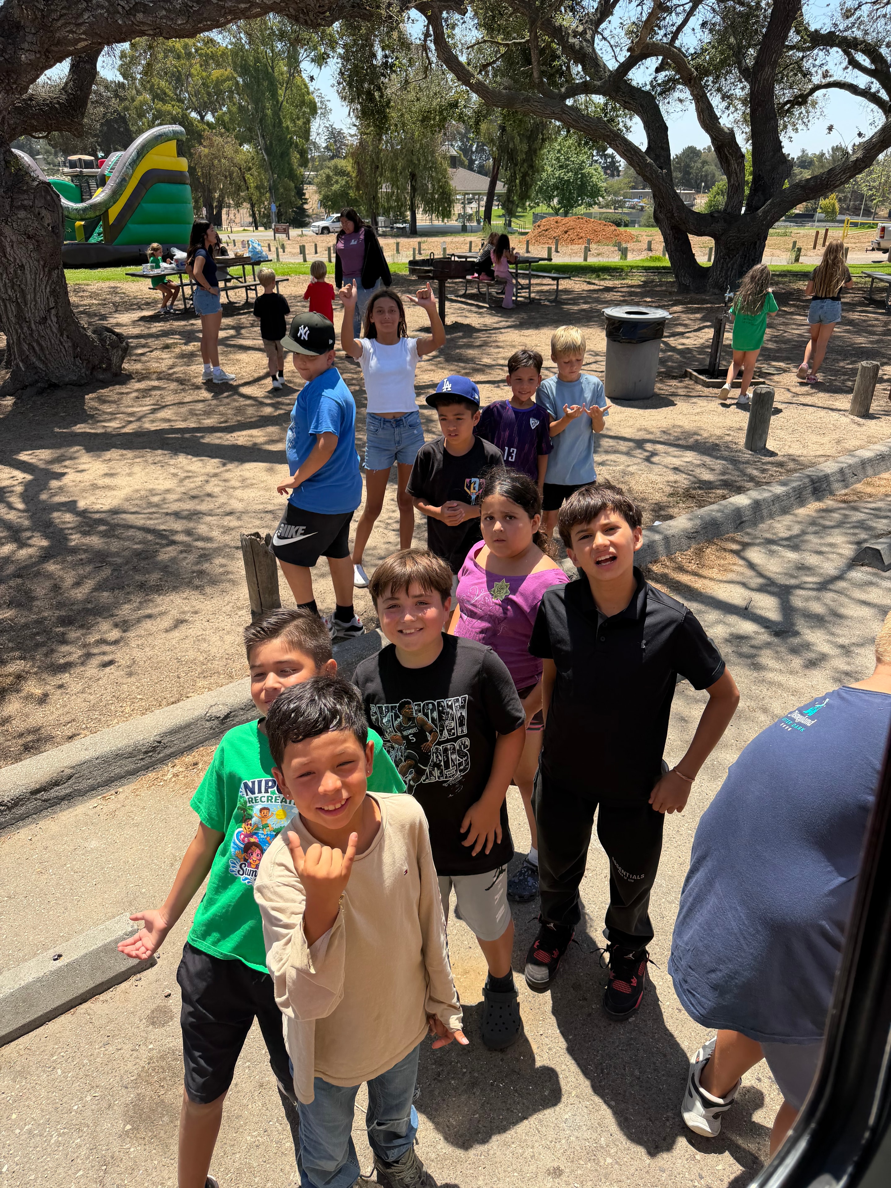 Group of excited kids giving shaka signs at a Shaka Shak school event